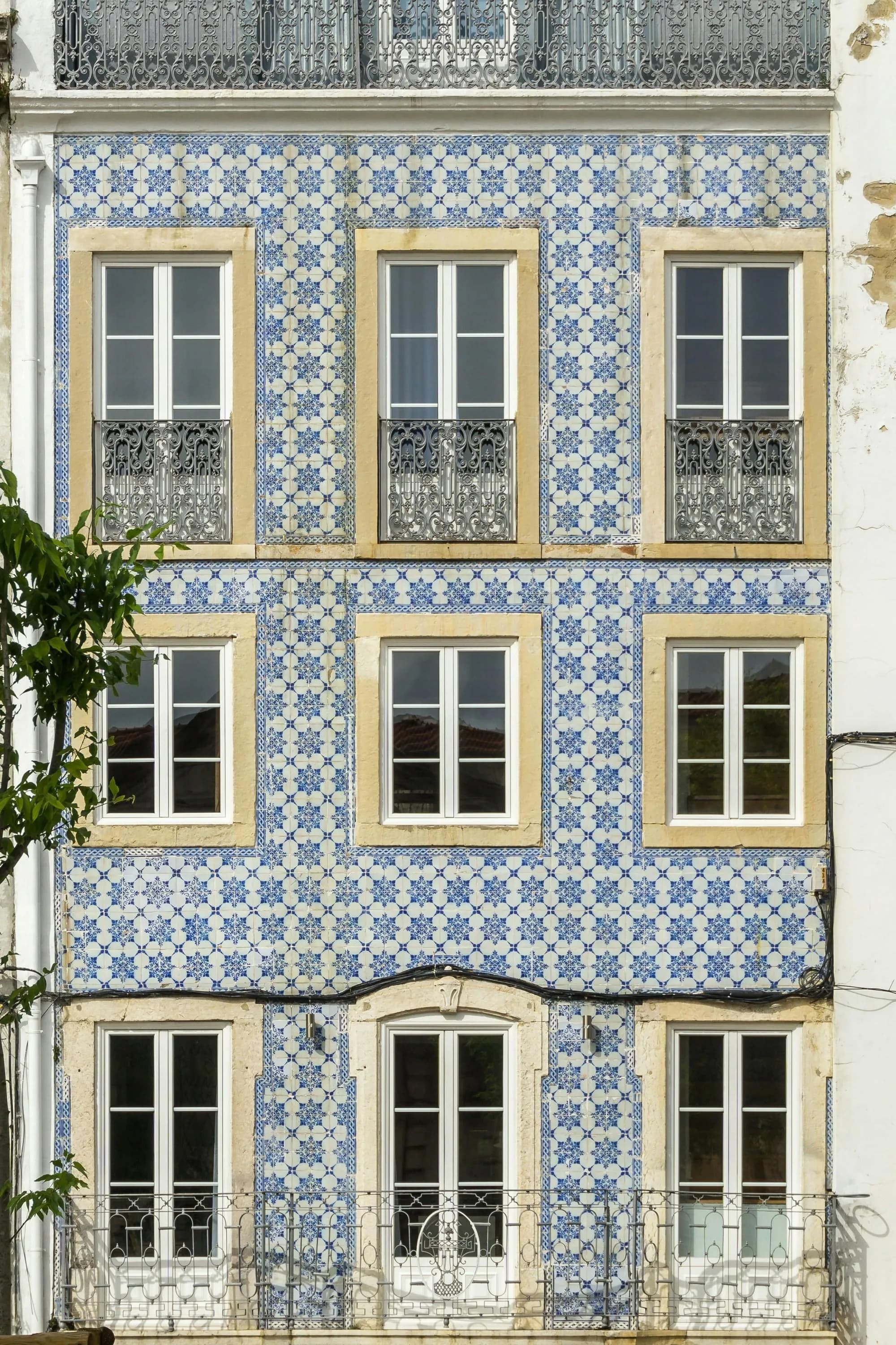 A Portuguese urban corner with local businesses below lived-in apartments